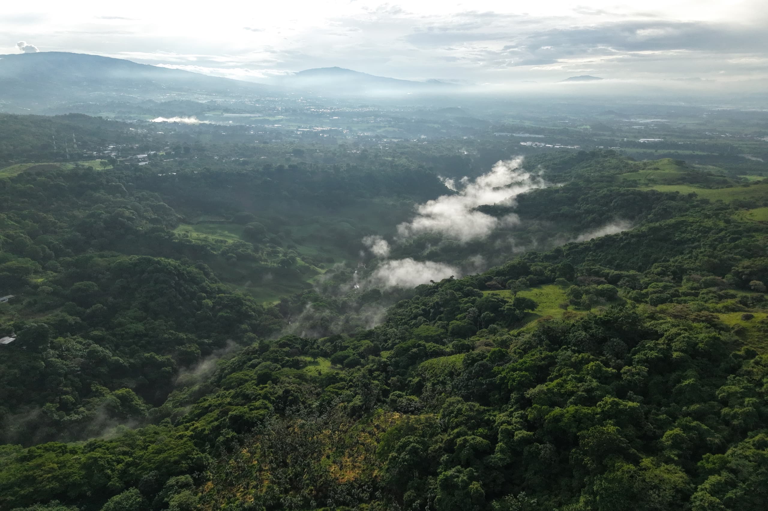 Morning mist over forested hills and farmland near Atenas, Costa Rica